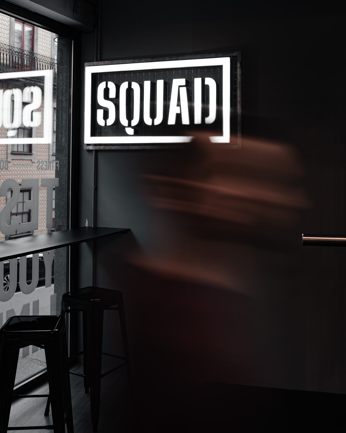 Squad Fitness Boutique backlit stencil logo sign inside the Porto studio